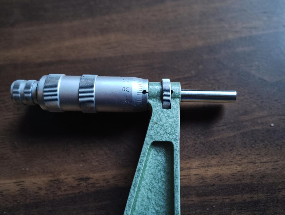 Close-up of the Mauser micrometer thimble, graduated scale, locking ring, and measuring spindle.
