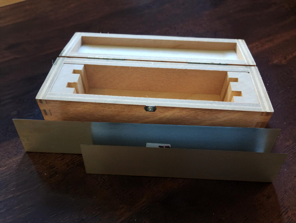 Vintage MICROM precision straightedge set displayed horizontally in front of the open wooden storage case.
