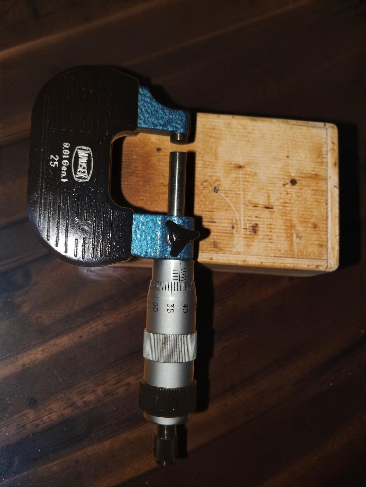 Back view of the Mauser outside micrometer showing the black frame, blue hammered finish, and measuring spindle.
