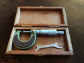 NOS Helios 0–25 mm outside micrometer in an open wooden case with adjustment wrench.
