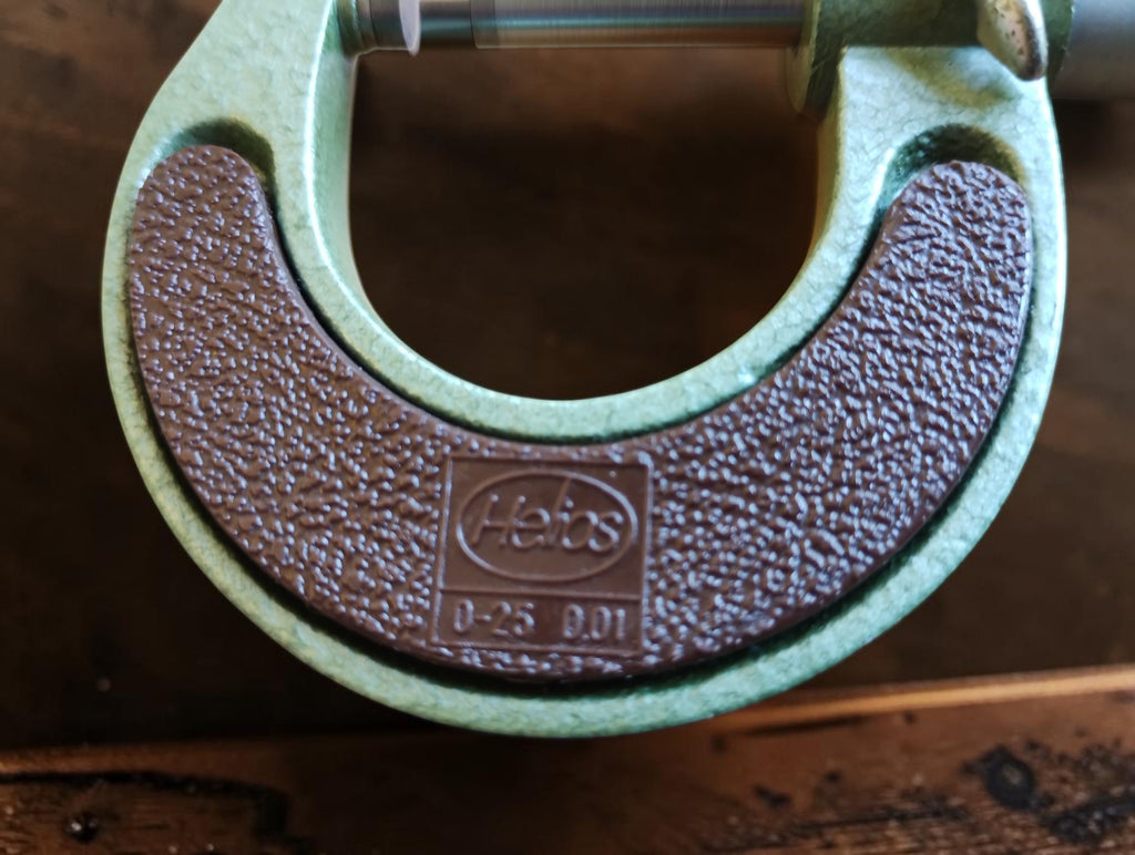 Close-up of the Helios logo and 0–25 mm, 0.01 mm markings on the NOS outside micrometer.
