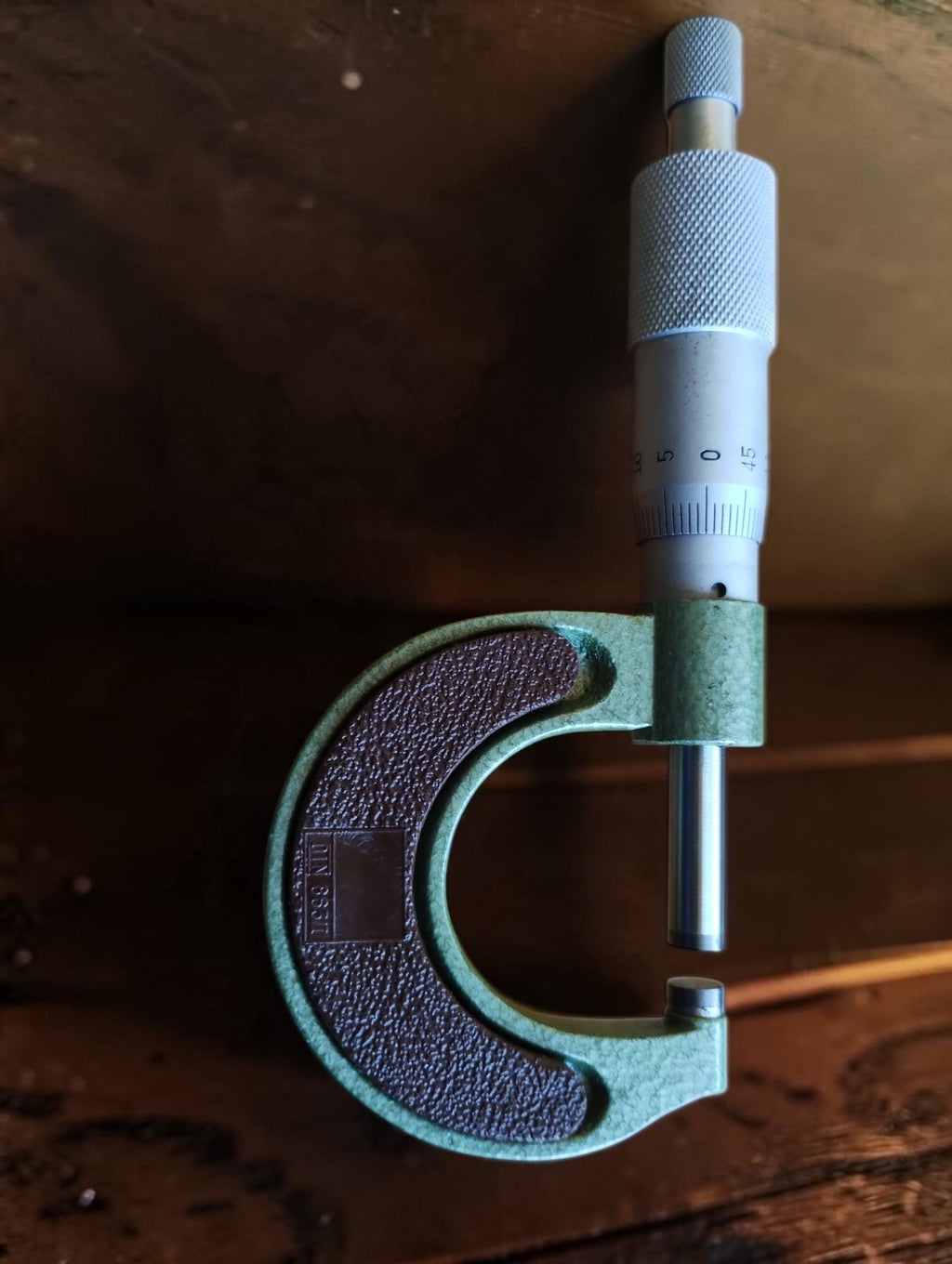 NOS Helios 0–25 mm outside micrometer showing the spindle, anvil and textured brown grip.

