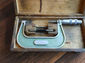 Vintage MAUSER 75–100 mm outside micrometer in an open wooden case with reference rod and adjustment wrench
