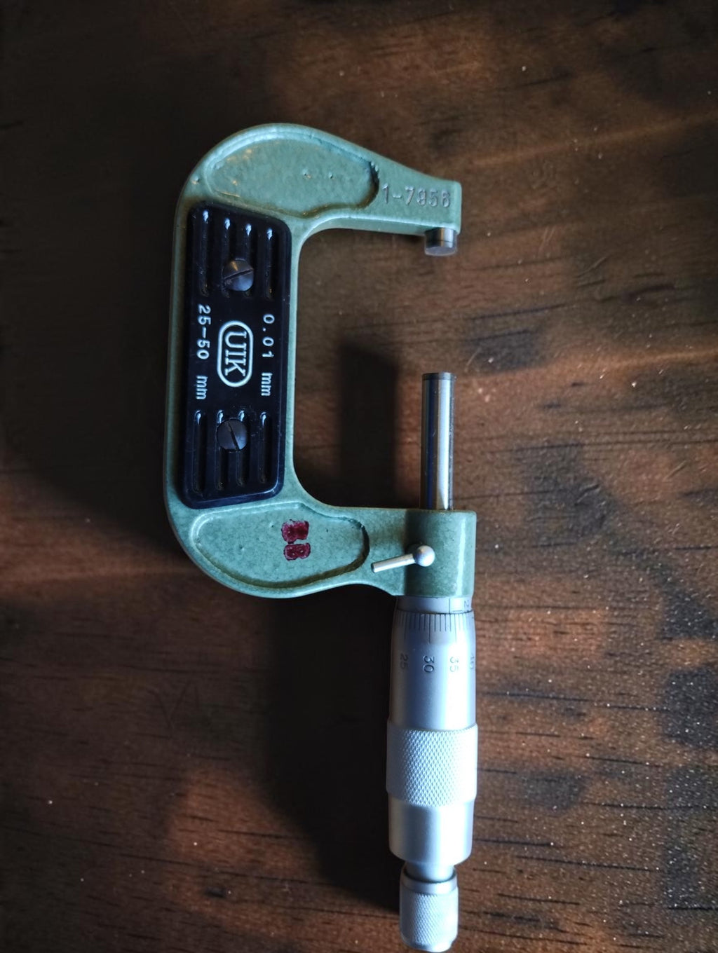 Full view of the vintage UIK 25–50 mm outside micrometer with green frame and silver-colored thimble.
