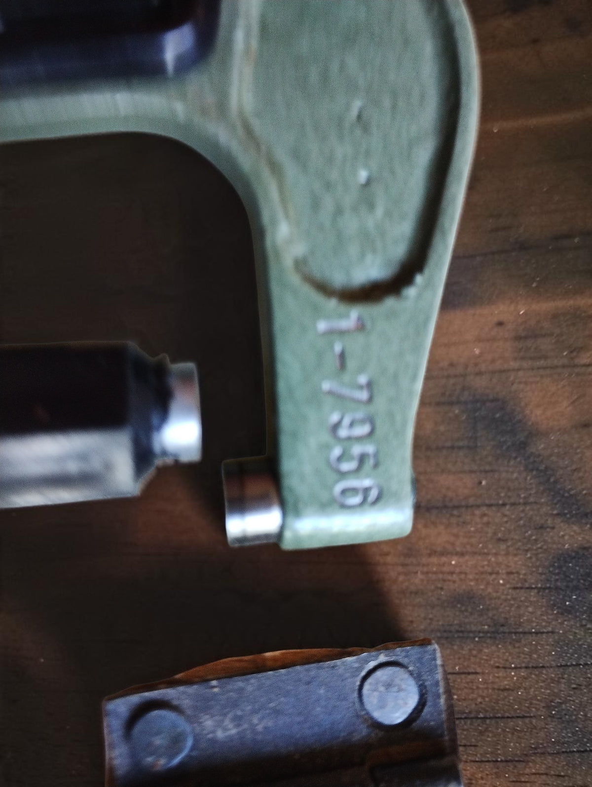 Close-up of the number 1-7956 stamped into the green frame of the UIK micrometer.
