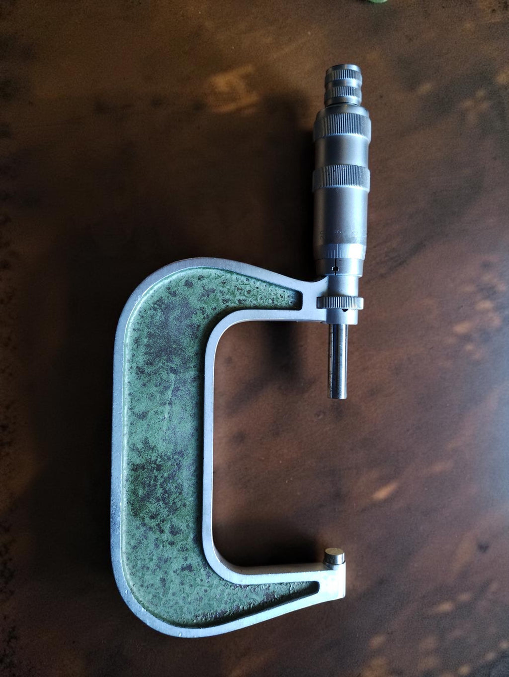 MAUSER outside micrometer showing the green frame, spindle and metal thimble
