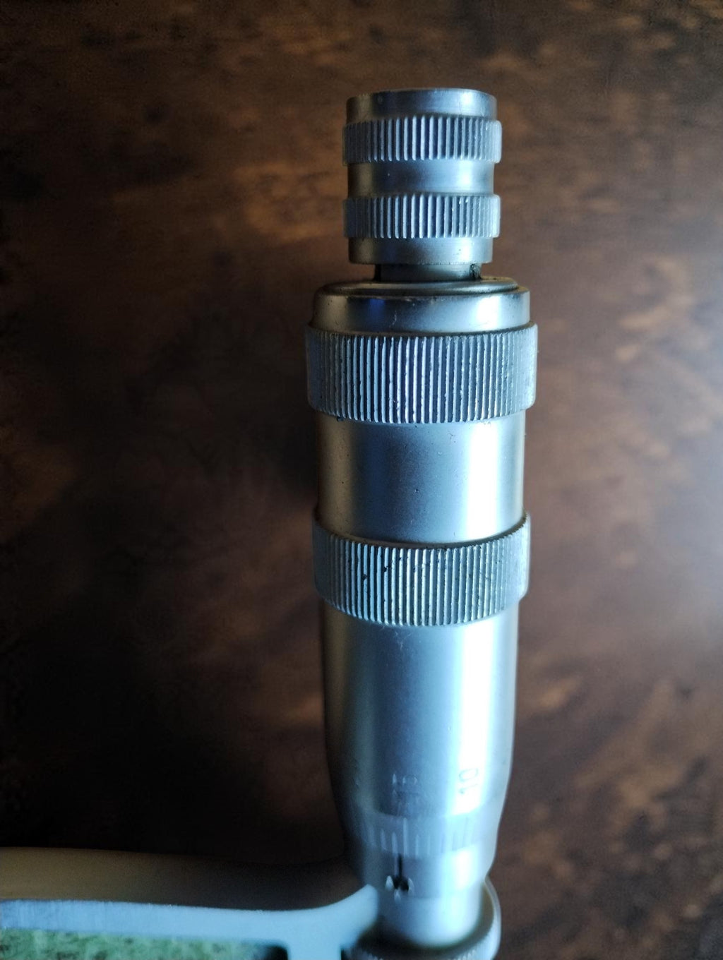 Close-up of the MAUSER micrometer thimble and knurled adjustment controls
   