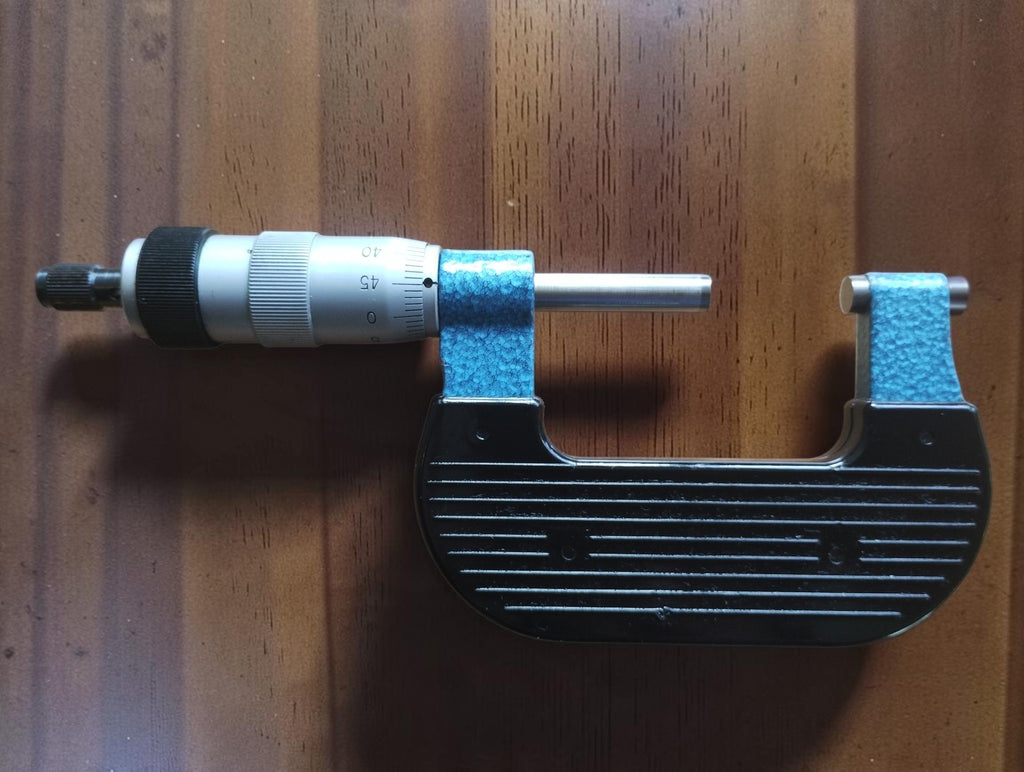 Rear view of the vintage Mauser outside micrometer showing the ribbed grip, blue frame, spindle and graduated thimble.
