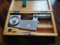 Feinmesszeugfabrik Suhl 25–50 mm indicating micrometer in an open wooden storage case.
