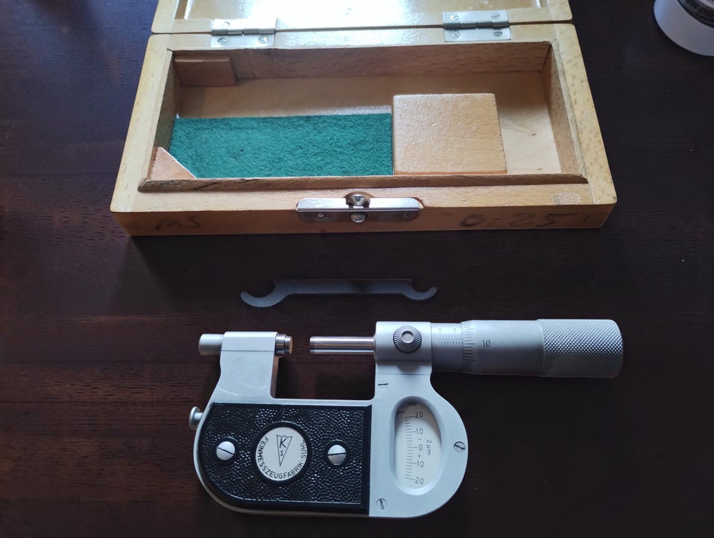Suhl Passameter beside its open wooden storage case and adjustment wrench.
