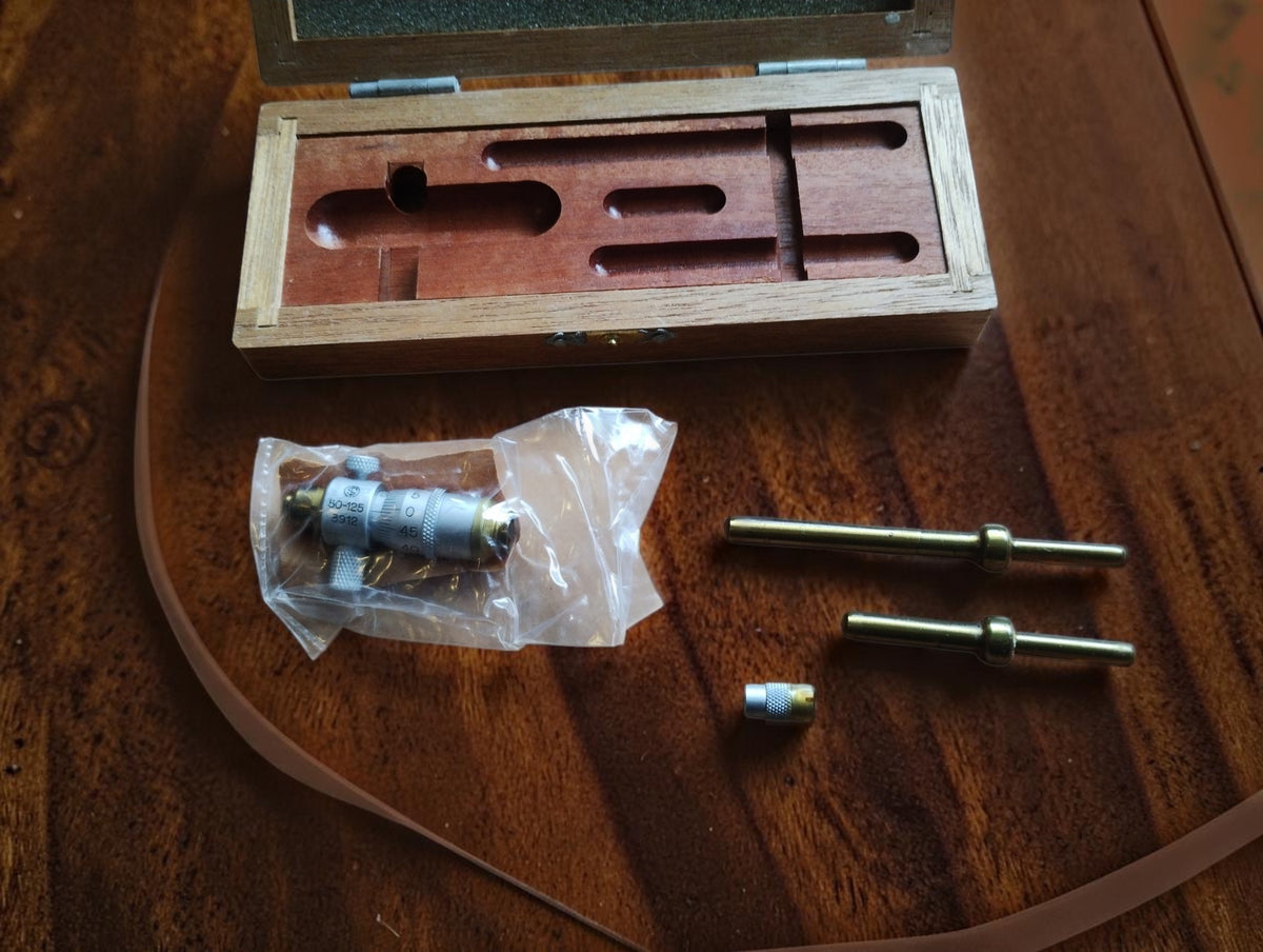 Somet 50–125 mm inside micrometer with two extension rods and a small component beside the wooden case, NOS, still in protective grease.
