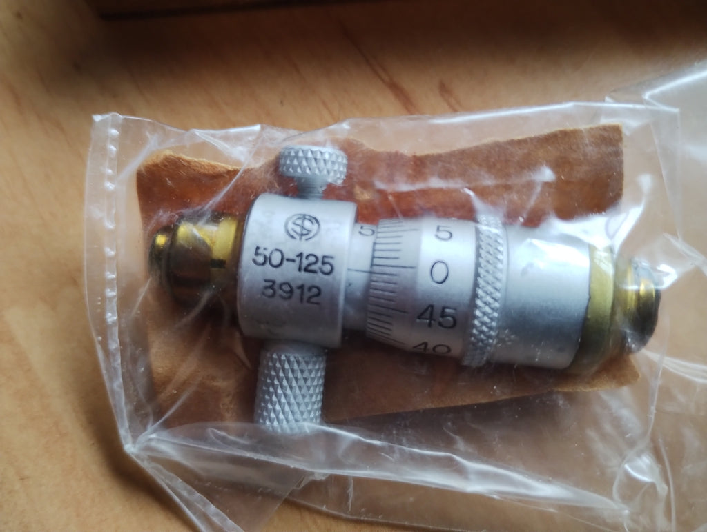 Somet inside micrometer head marked 50–125 and 3912 in protective wrapping, NOS (New Old Stock), still in protective grease.
