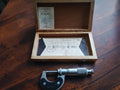 MATRA 0–25 mm outside micrometer beside its open wooden case with inspection certificate and technical drawing
