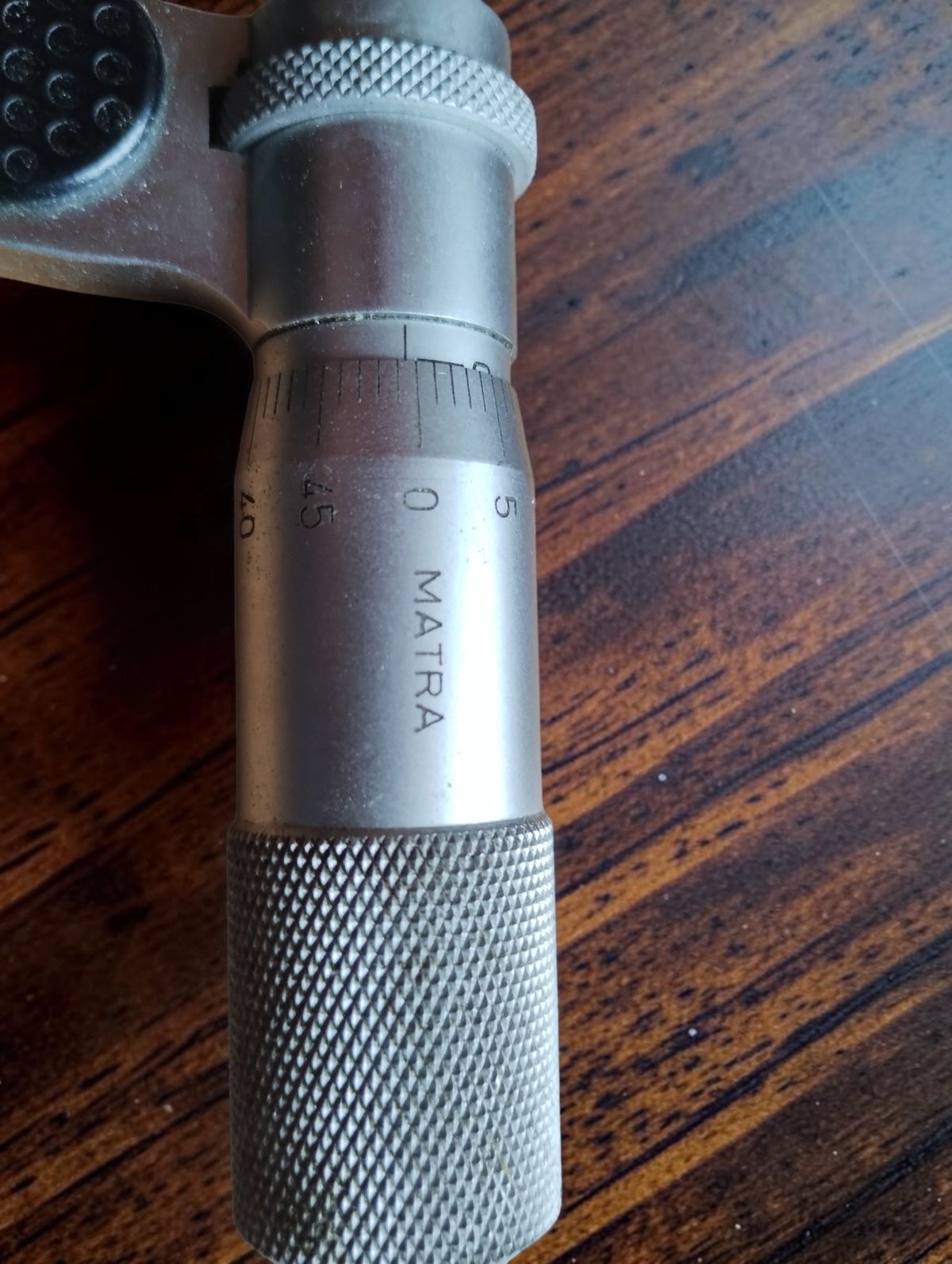 Close-up of the graduated micrometer thimble with the MATRA name and knurled adjustment grip
