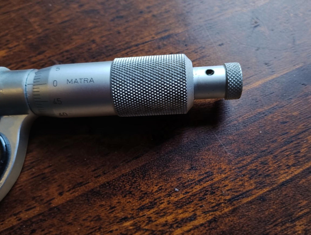 Detail of the MATRA micrometer adjustment grip and knurled end knob
