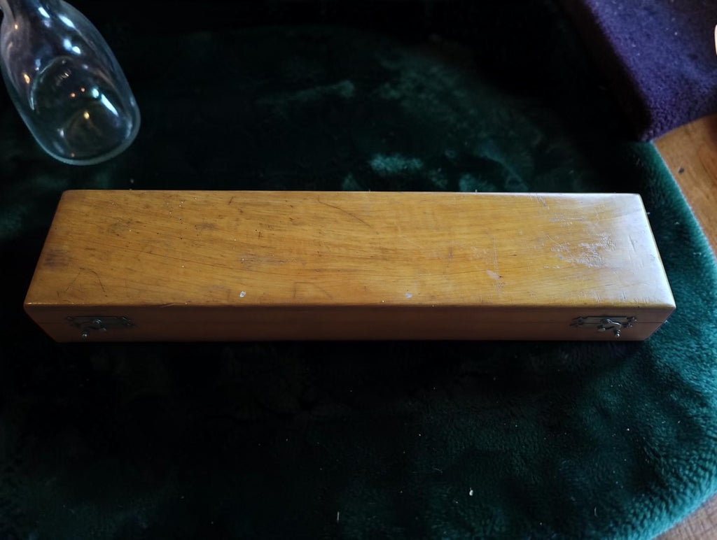 Closed wooden case with two metal clasps for the Gebr. Caminada Rotterdam hydrometer and thermometer set
