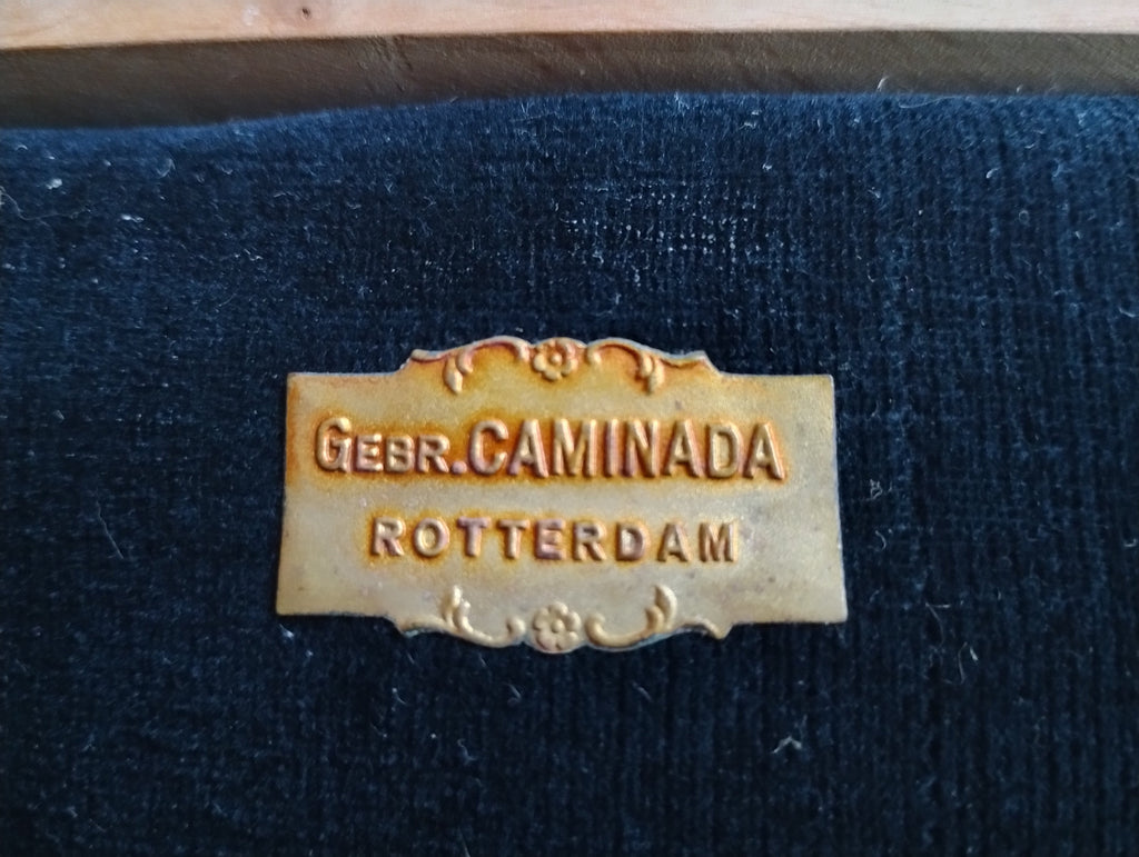 Decorative Gebr. Caminada Rotterdam maker's label inside the velvet-lined wooden instrument case
