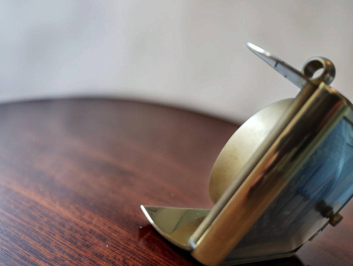 Side view of the vintage Fischer barometer, showing the curved rear housing, gold-tone frame and tabletop base.

