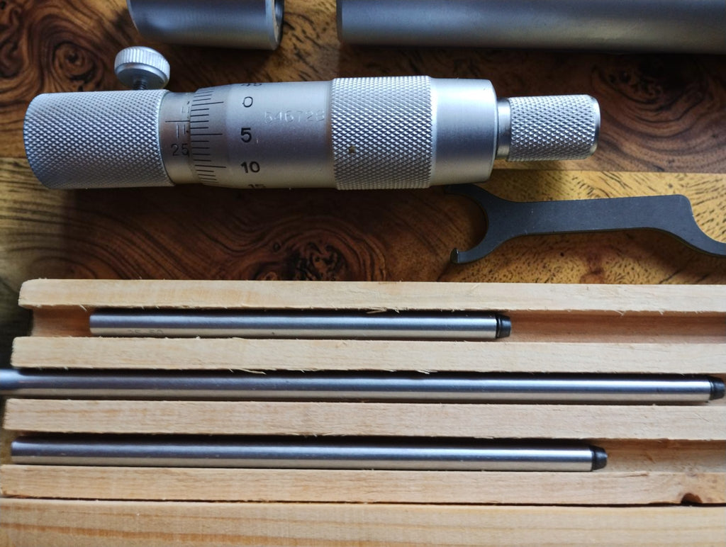 Close-up of the 75 mm extension sleeve resting in the fitted wooden storage case.
