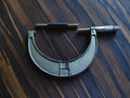 Hommelwerke 125–150 mm outside micrometer with textured metal frame and separate setting standard.
