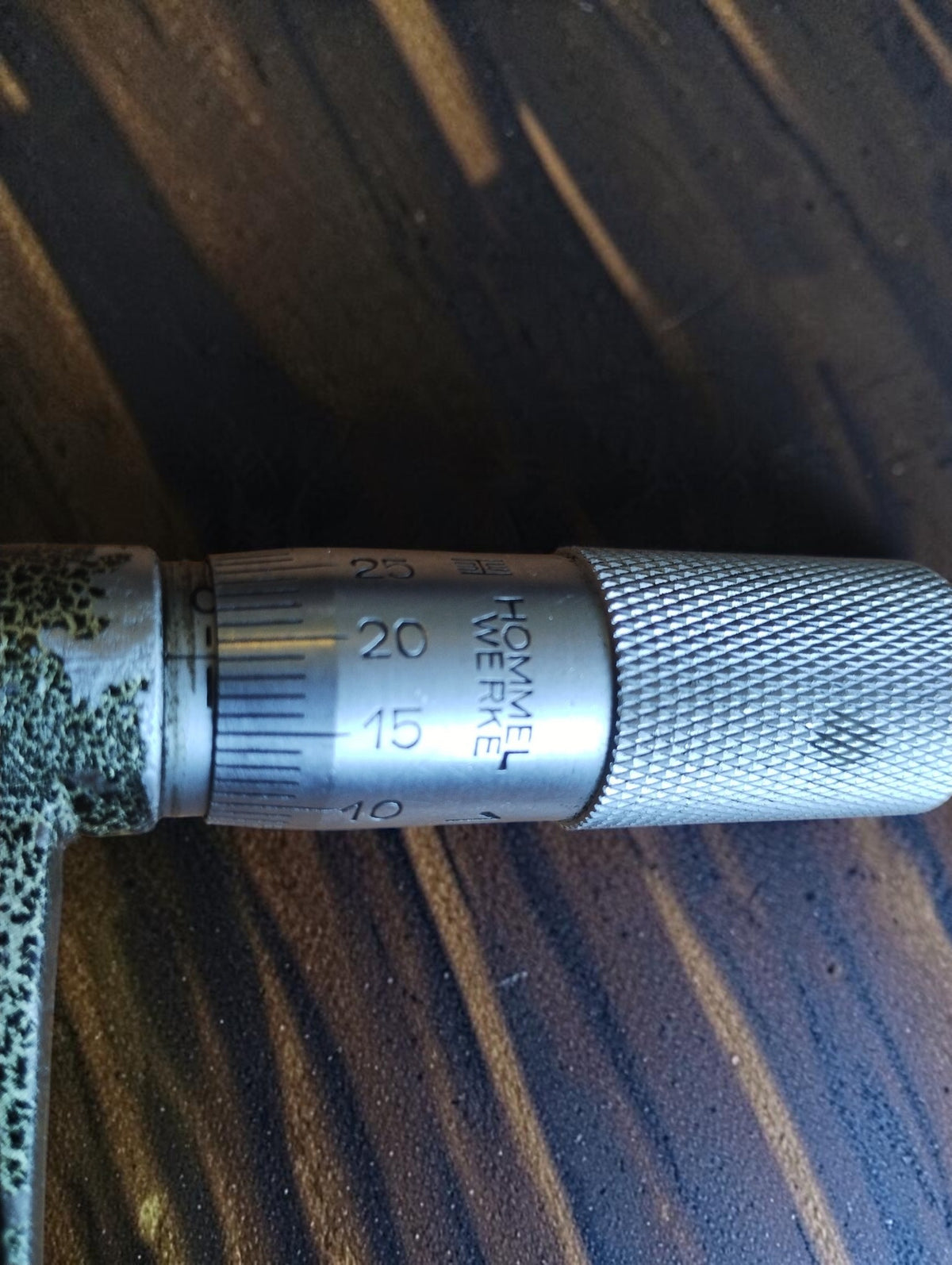 Hommel Werke maker's marking on the graduated thimble of the vintage outside micrometer.
