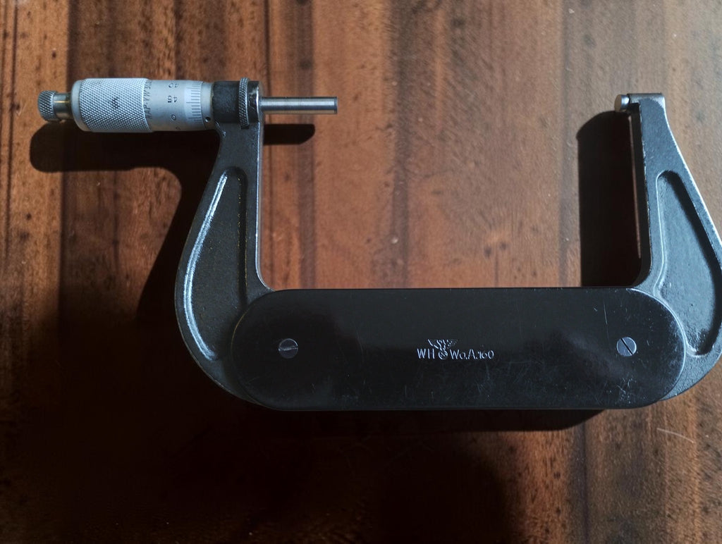 Rear view of the P. Roch outside micrometer showing its dark frame, silver thimble and WH and WaA160 markings.
