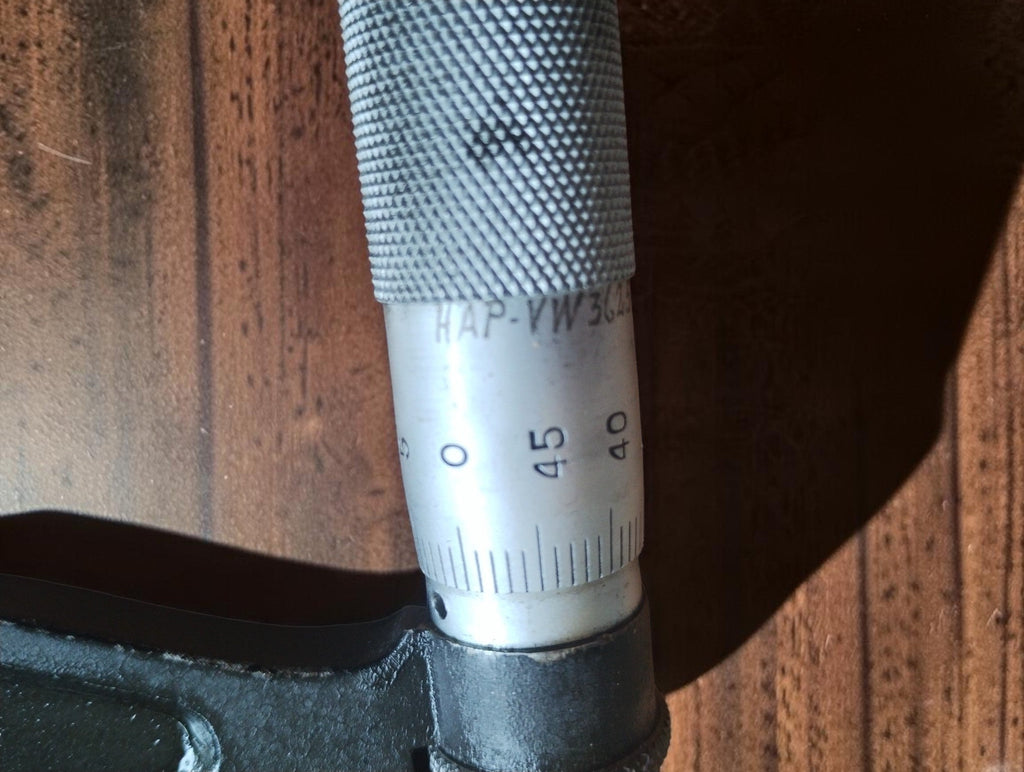 Detail of the P. Roch micrometer's graduated thimble, knurled grip and dark frame.
