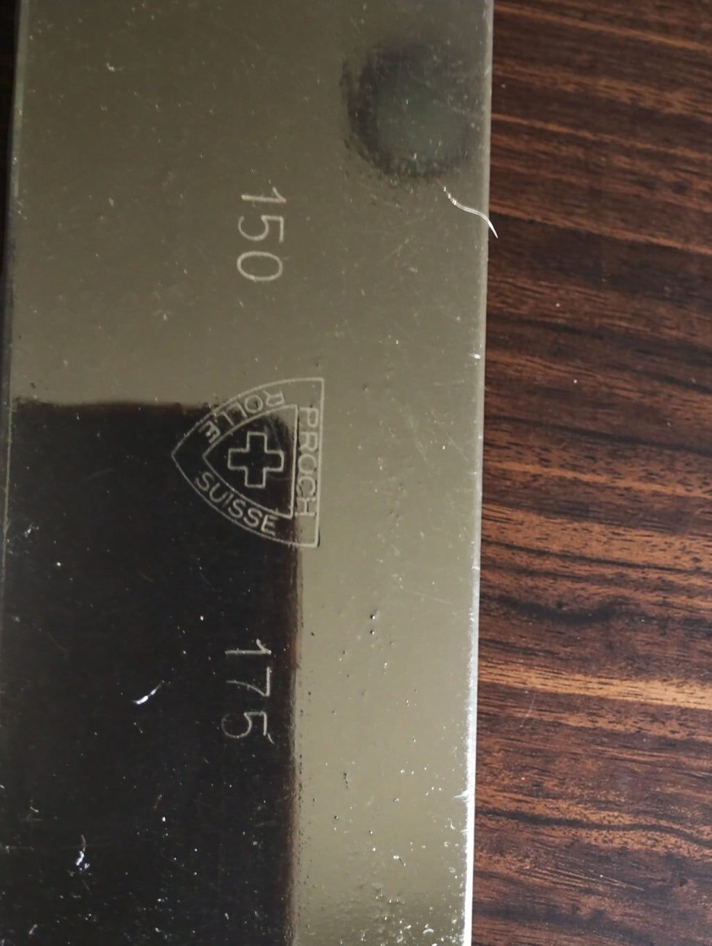 Close-up of the P. Roch Rolle Suisse shield logo with Swiss cross and 150 and 175 range markings.
