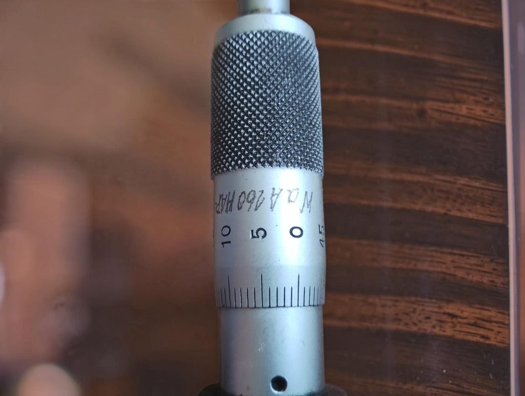 Close-up of the P. Roch micrometer thimble showing its knurled grip, graduated scale and handwritten engraving.
