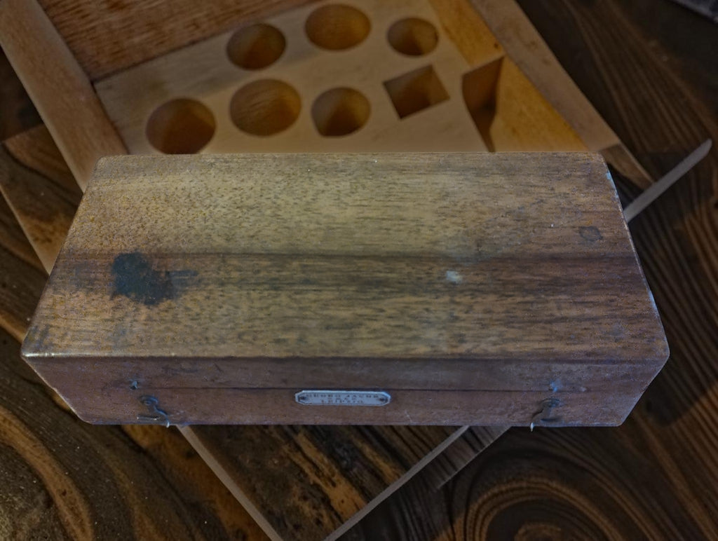 Closed wooden case for the Georg Jacob Leipzig watchmaker's tool set, showing wear and discoloration
