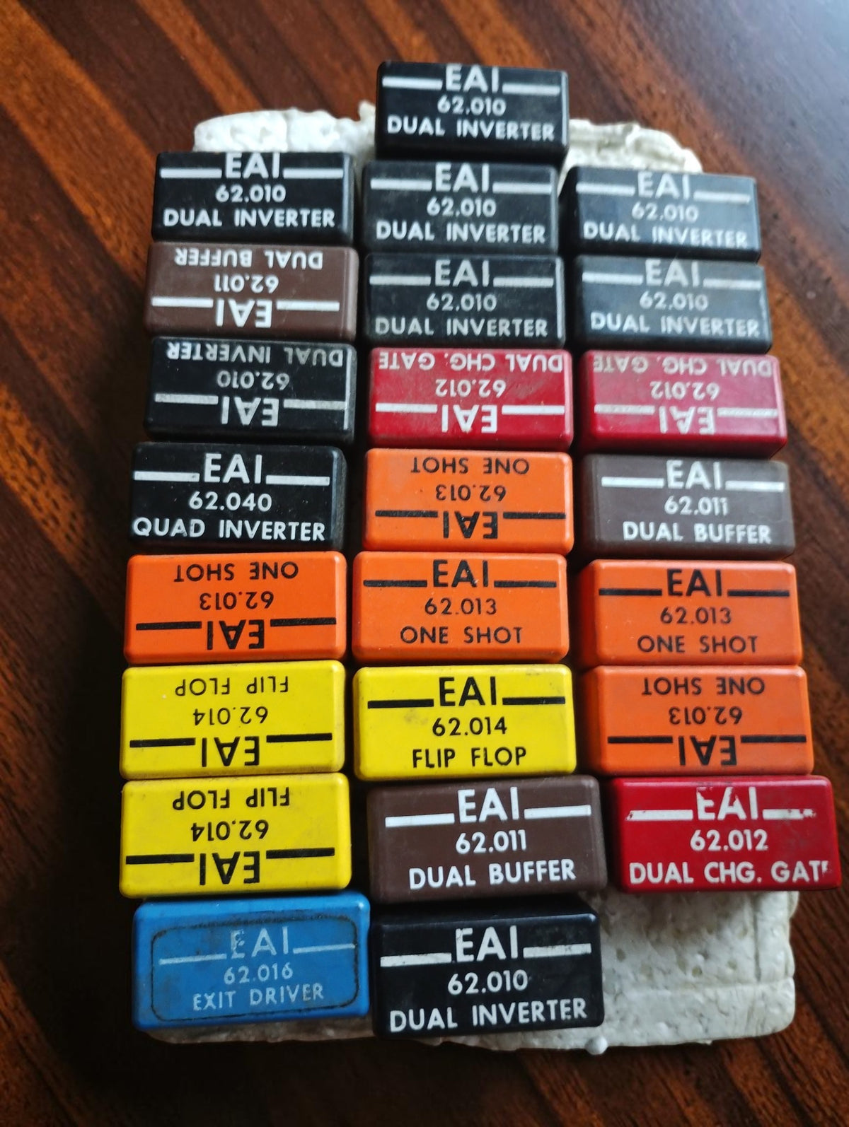 Collection of vintage EAI plug-in computer modules with color-coded housings and labeled model numbers
