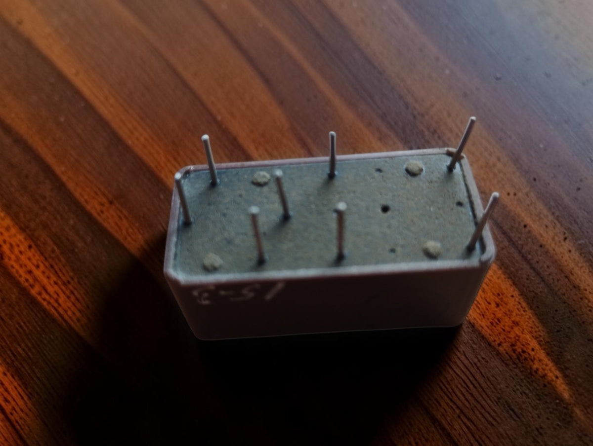Underside of an EAI plug-in computer module showing the base and connector pins
