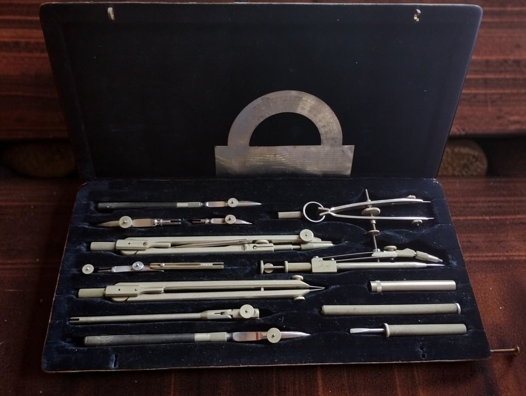 Precision drafting set attributed to Gebrüder Haff Pfronten, with compasses, drawing pens and a metal protractor in an open fitted case.

