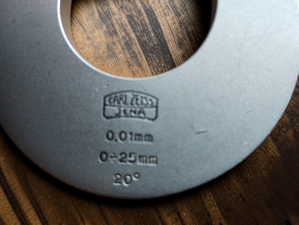 Carl Zeiss Jena micrometer markings showing the 0–25 mm range, 0.01 mm graduations, and 20° inscription.
