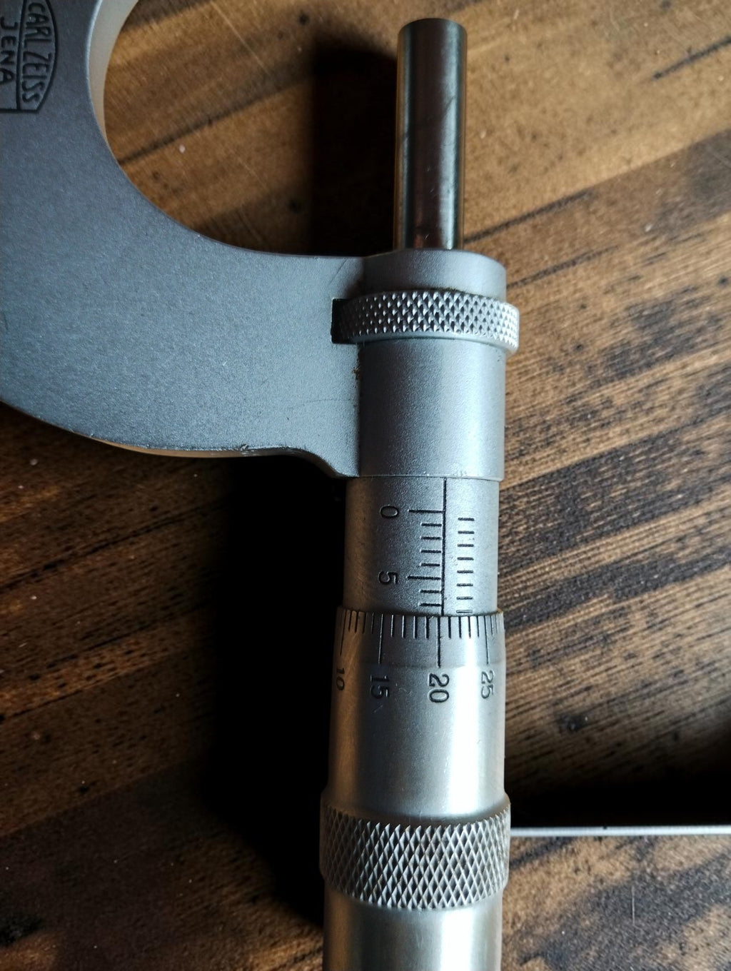 Close-up of the Carl Zeiss Jena micrometer sleeve scale, graduated thimble, and knurled adjustment surfaces.
