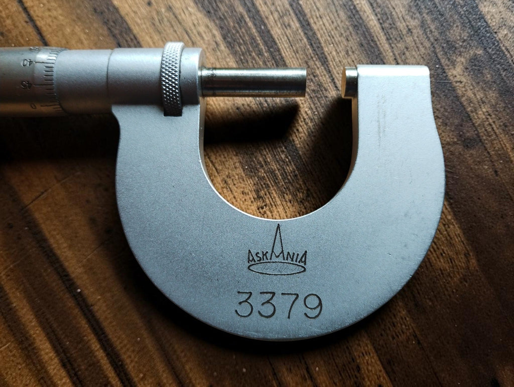 Vintage micrometer showing the Askania logo, number 3379, spindle, and anvil.
