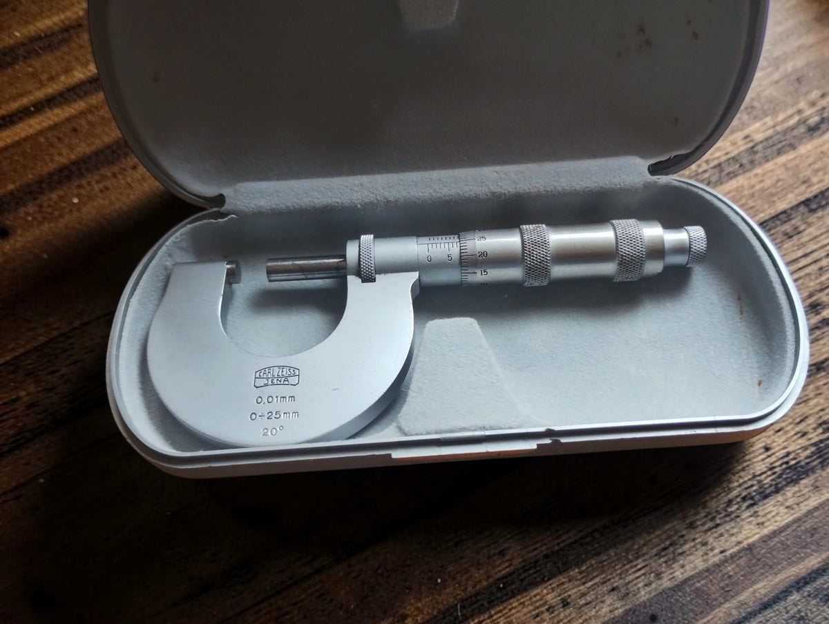 Carl Zeiss Jena 0–25 mm outside micrometer in an open light gray fitted storage case.
