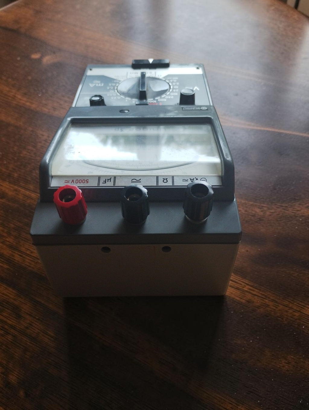Metrawatt Unigor 3p viewed from the terminal end, showing two black terminals, the red 5000V terminal and the raised meter window.
