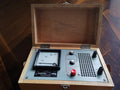VEB Energiekombinat Potsdam NES I/62 electrical safety tester in an open wooden case with analog voltmeter and controls.
