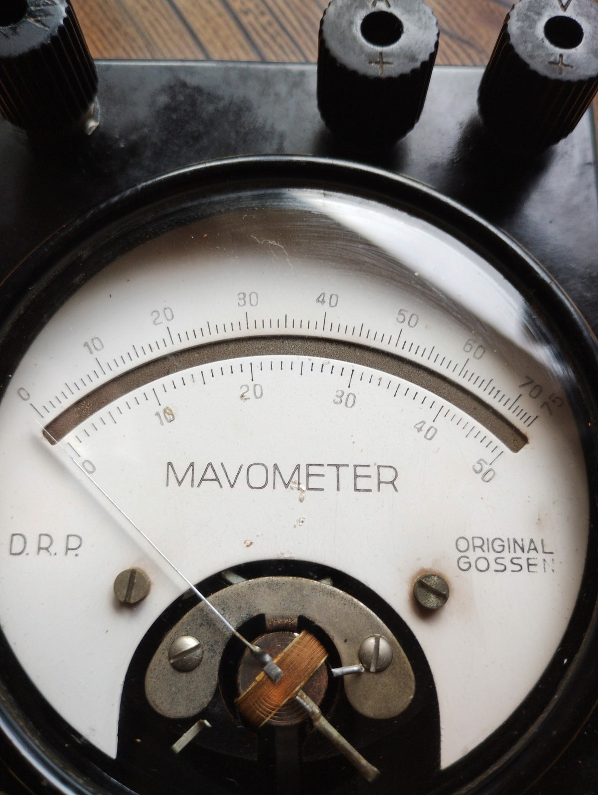 Close-up of the Gossen Mavometer dial showing dual scales, D.R.P. marking and exposed moving-coil mechanism.
