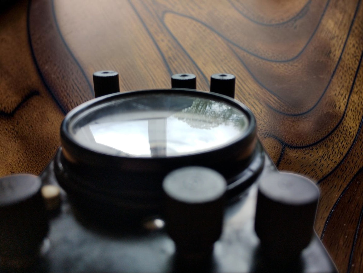 Low side view of the Gossen Mavometer showing the raised glass dial window and terminal arrangement.
