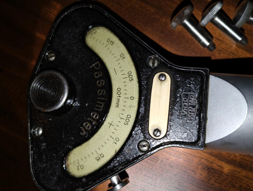 Close-up of the Carl Zeiss Jena logo and curved Passimeter scale marked 0.01 mm on the black textured housing

