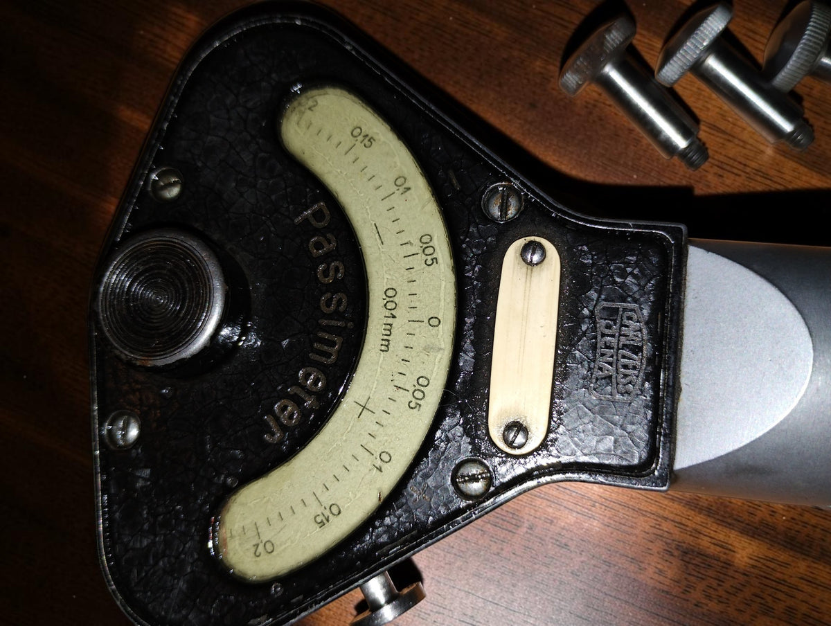 Close-up of the Carl Zeiss Jena logo and curved Passimeter scale marked 0.01 mm on the black textured housing
