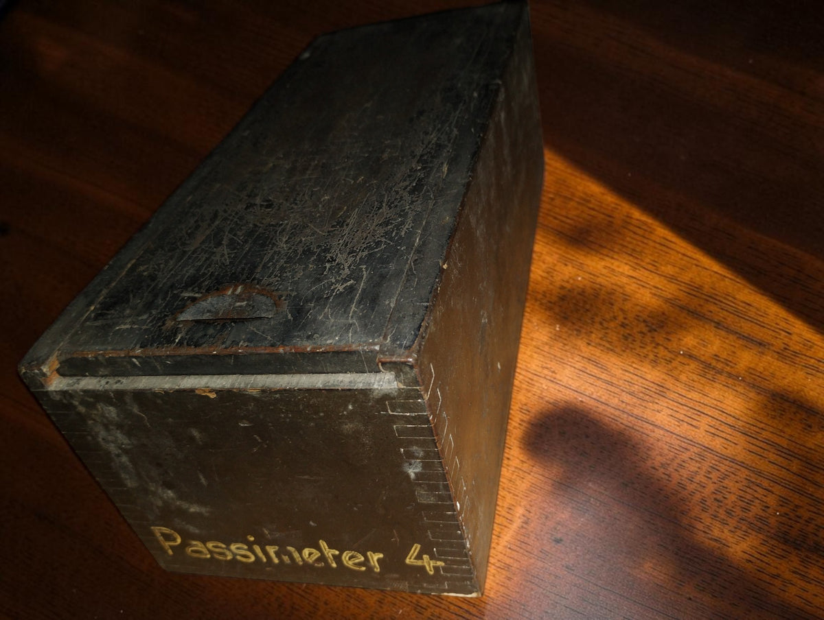 Vintage wooden sliding-lid case marked Passimeter 4, showing surface wear and dovetail corner joints
