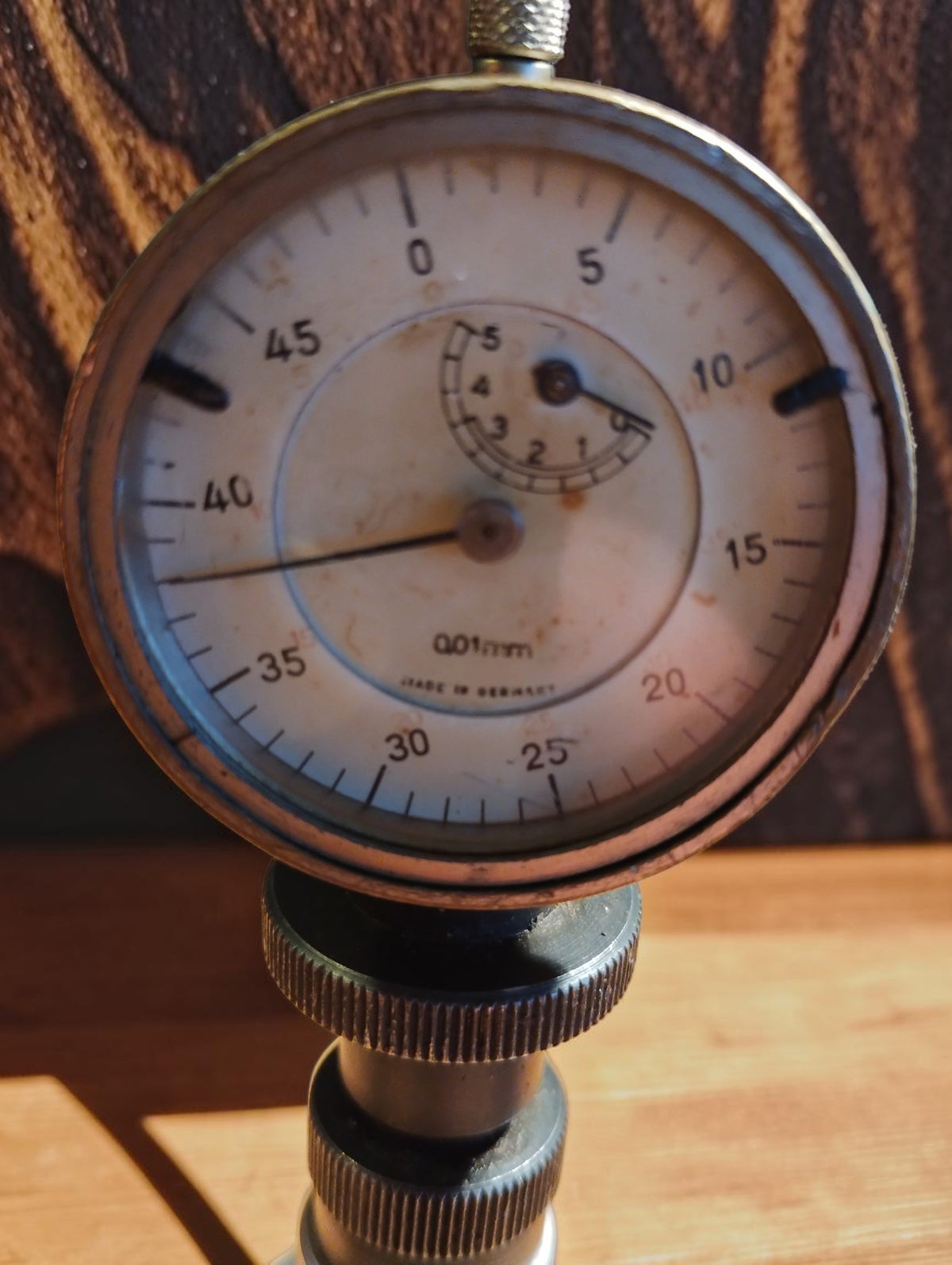 Close-up of the dial indicator face with numbered scale and small revolution counter
