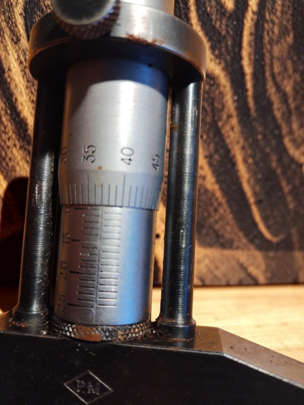 Close-up of the engraved micrometer scales and metal measuring bridge
