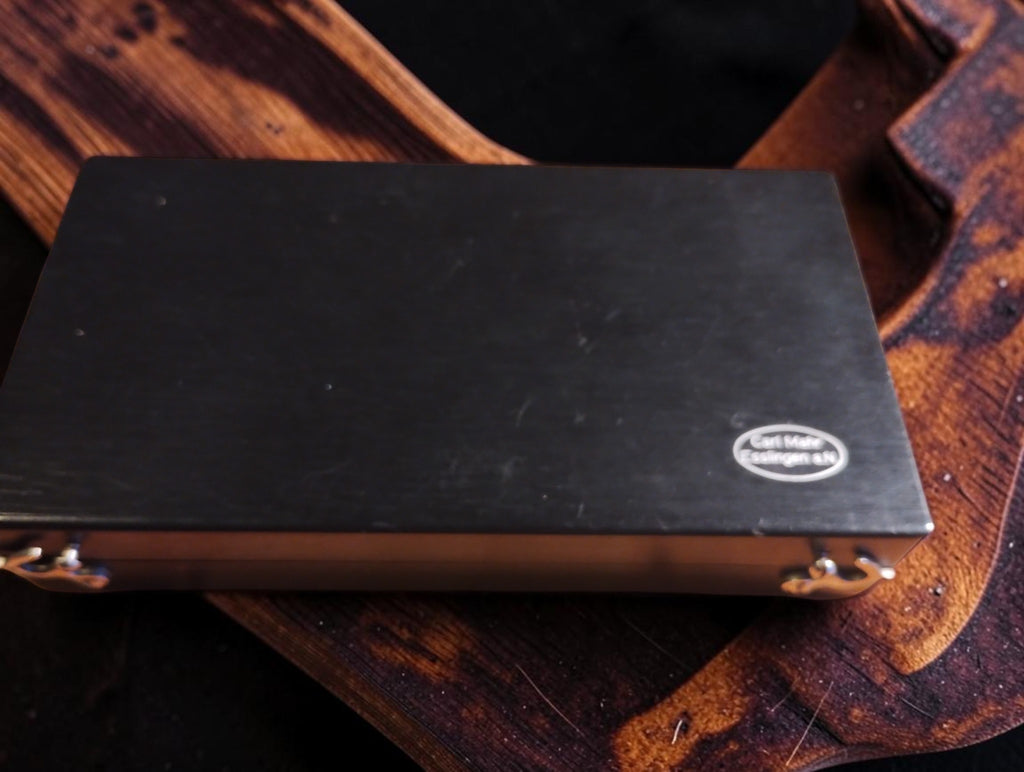 Closed black wooden case with oval Carl Mahr Esslingen a.N. maker's logo
