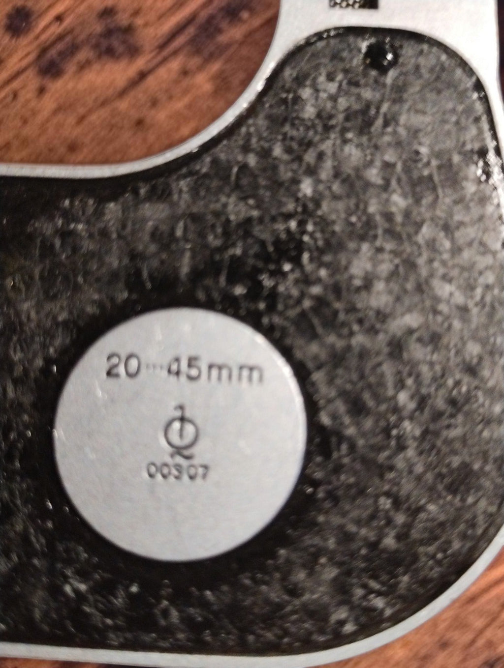 Close-up of the Carl Zeiss Jena micrometer plate marked 20–45 mm and 00307 on the textured black frame.
