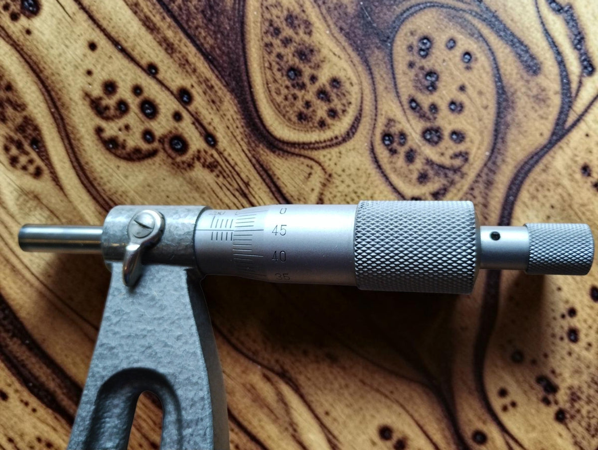 Detail of the Mahr outside micrometer spindle assembly, showing the knurled thimble and locking lever.
