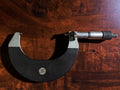 Opposite-side view of the 75–100 mm outside micrometer showing the TGL label, scale and locking lever.
